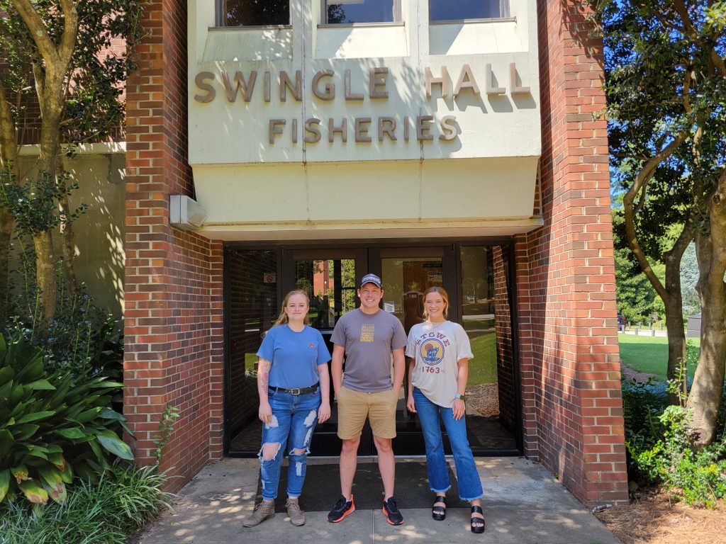 Dr. Whelan and lab members Sam Donohoo and Mia Adcock in front of Swingle Hall on the Auburn University campus.