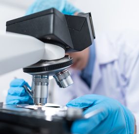 scientist looking into a microscope